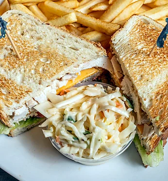 Clubhouse sandwich with coleslaw and fries