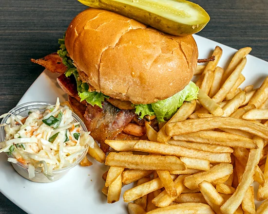 Ultimate Burger with bacon, lettuce and a pickle, served with fries and coleslaw